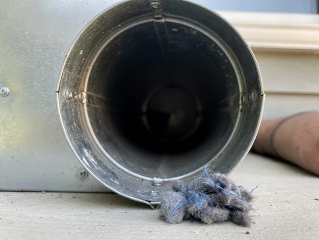 Cheshire Dryer Vent Cleaning technician using specialized equipment to clear severe dryer vent blockage in Cheshire